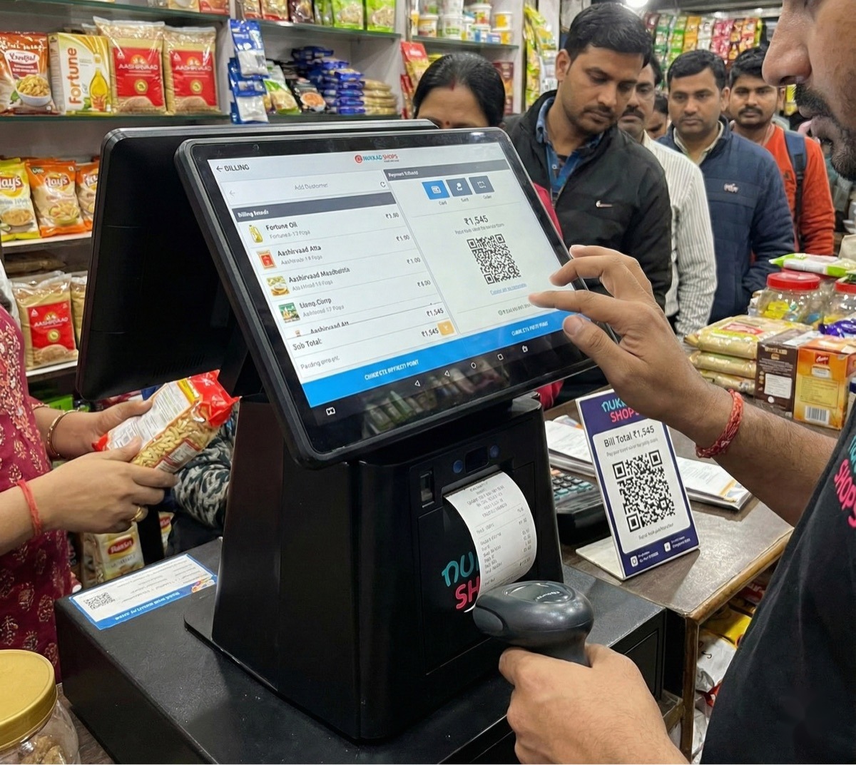 Customer paying at a NukkadShops POS billing counter