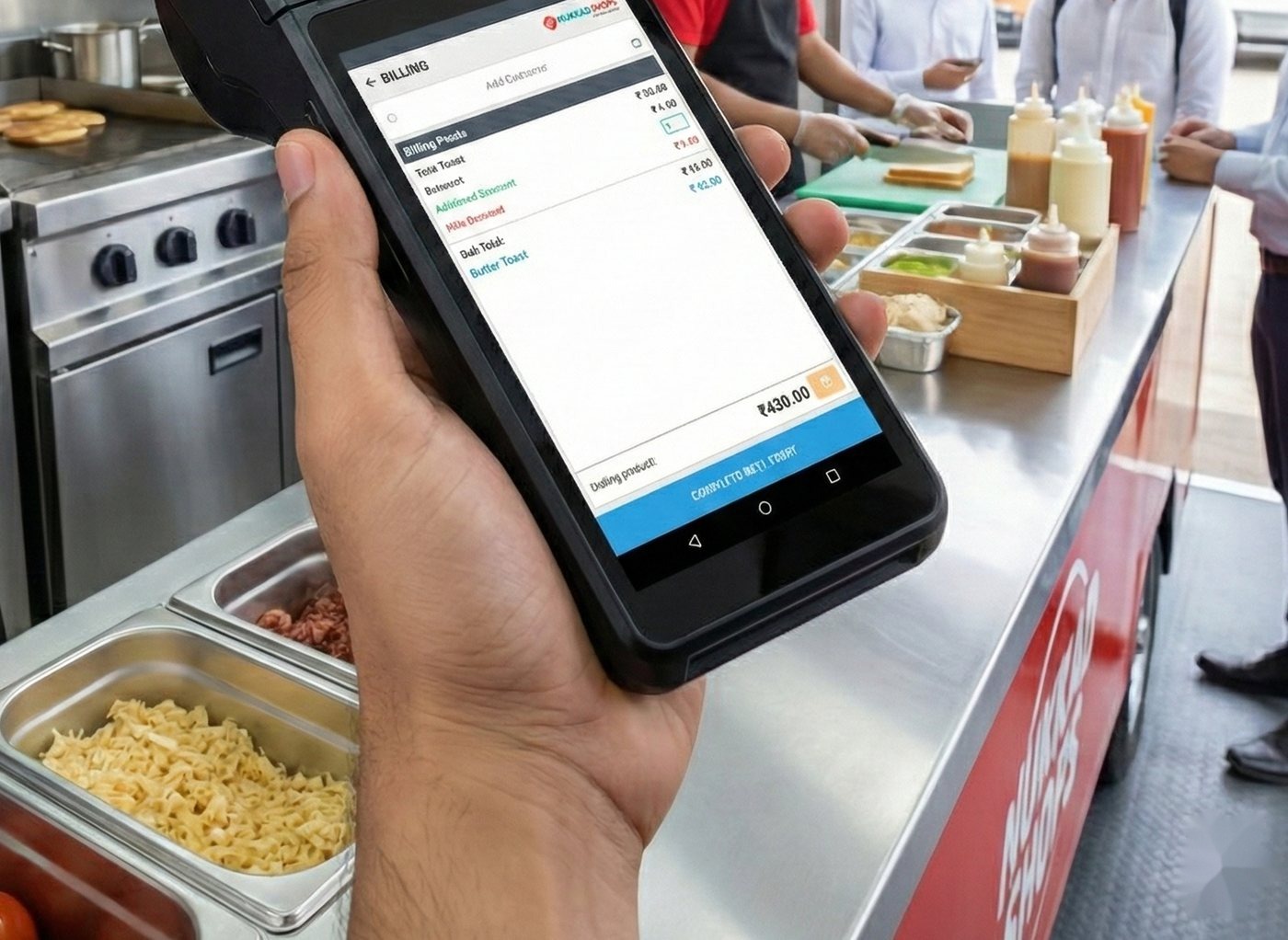 Waiter holding a handheld device running NukkadShops in a food-service kitchen